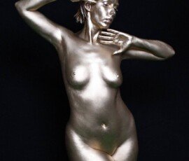 Modern metallic female nude art sculpture with dynamic pose and sleek finish. Shiny metallic female nude sculpture with pose and artistic expression.
